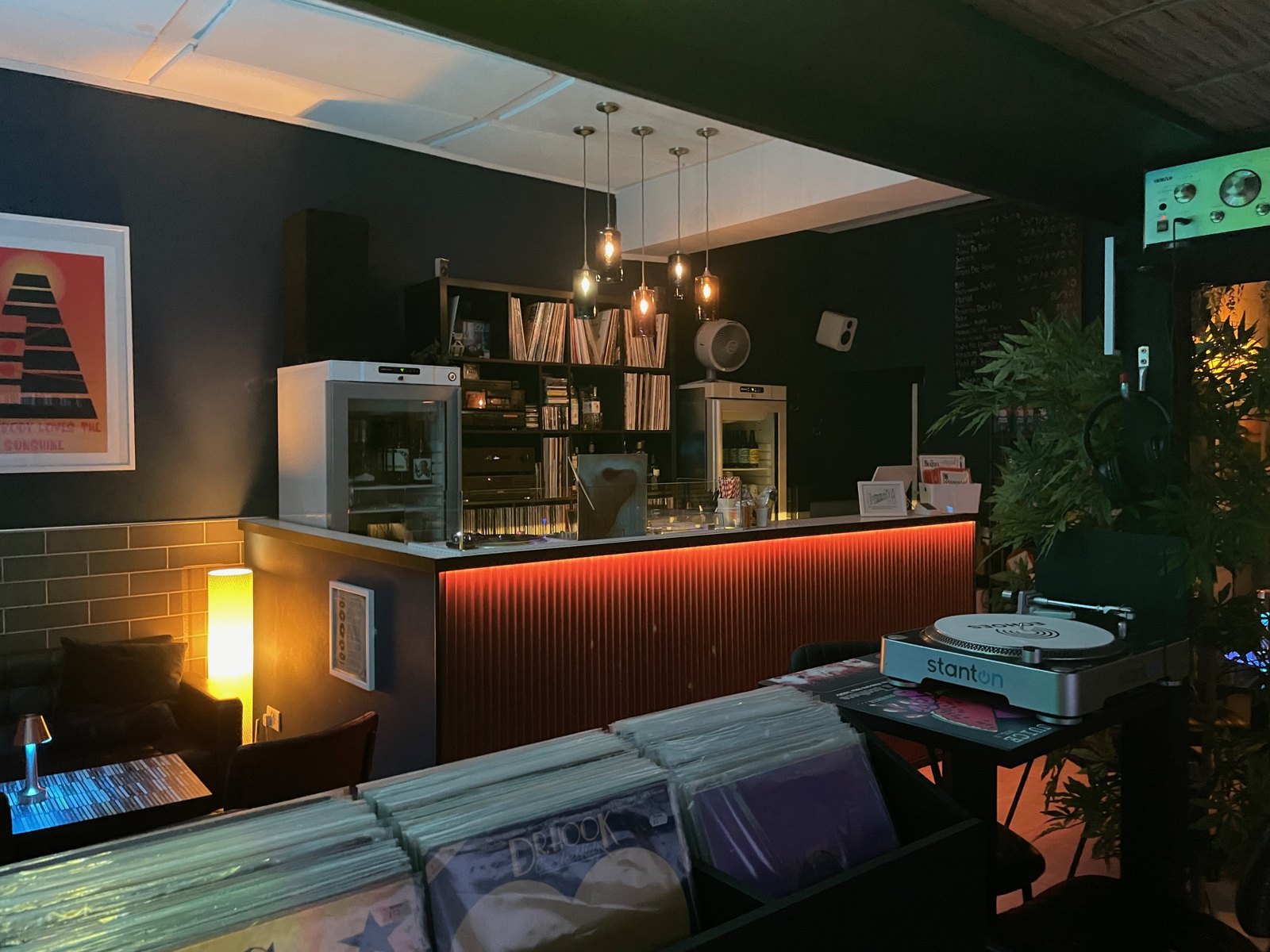 The long bar counter at Echoes glowing red in the evening