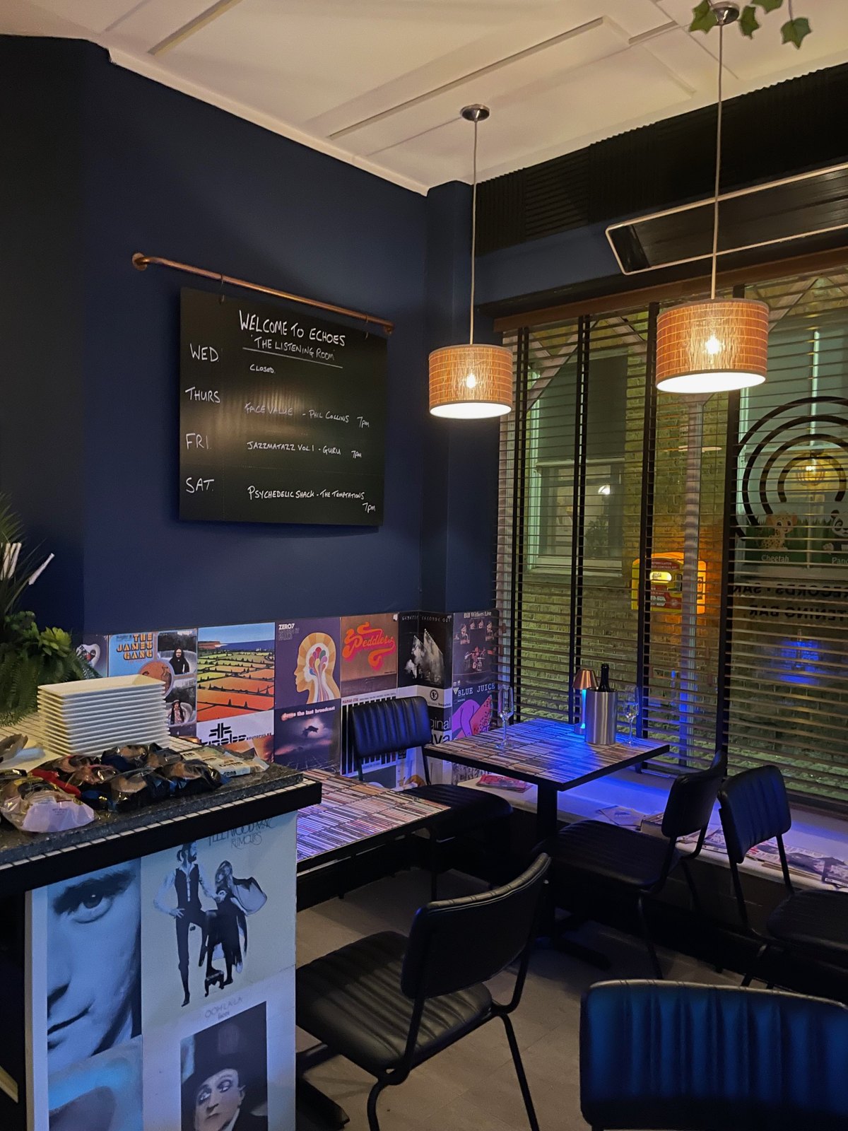 Tables and the welcome board inside Echoes during the day
